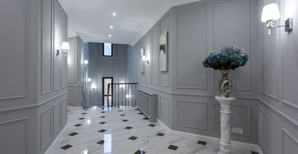 Hallway with wainscoting and marble floors